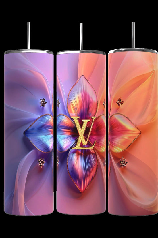 Three tall, cylindrical LV Puffy 20oz Tumblers by Kreative Kreationz come complete with metal straws. The first tumbler showcases a gradient background transitioning from blue to violet, adorned with a large, colorful floral centerpiece. The middle and right tumblers feature similar floral designs, each boasting unique color gradients and durable construction for maximum longevity.