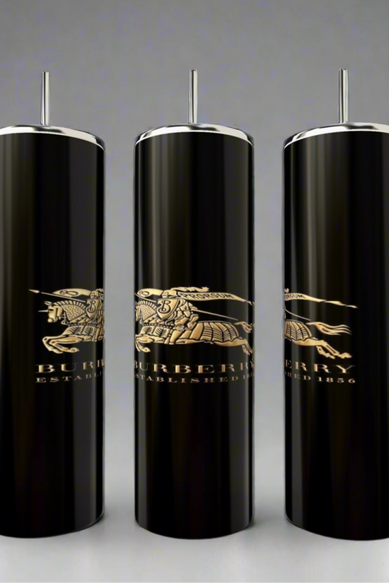 The Burberry 20oz Skinny Tumblers by Kreative Kreationz feature three elegant black cylindrical designs with silver accents and a gold Burberry logo, including 