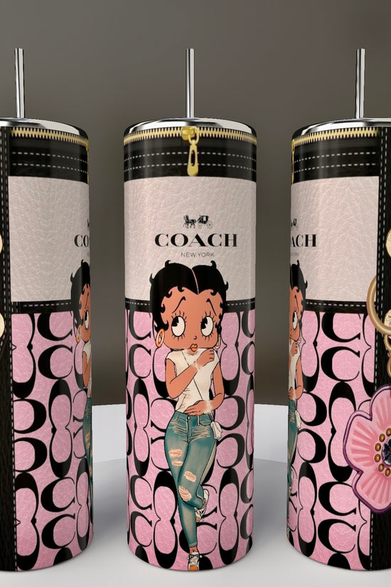 The Kreative Kreationz Betty B Coach 20oz Skinny Tumblers feature stylish cartoon character designs, including a Betty Boop in distressed jeans with a pink top, set against black and pink logos with decorative elements like flower charms. They come with spill-proof lids for added convenience.