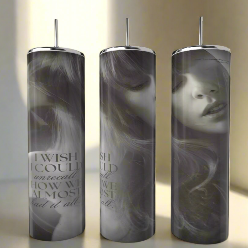 The Kreative Kreationz TTPD UNRECALL 20oz Tumbler features a black-and-white woman's face, "I WISH I COULD unrecall HOW WE ALMOST had it all" text, a metal straw, and a spill-proof lid for convenience.