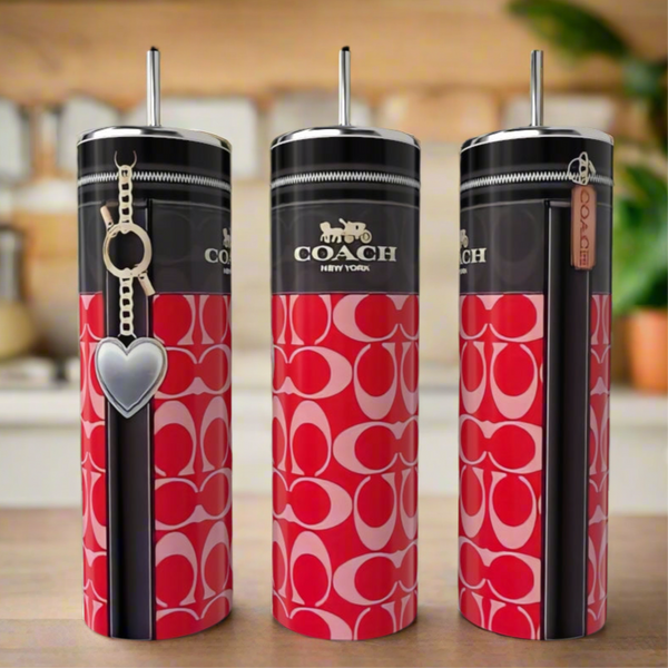 Three Coach Red 20oz Skinny Tumblers by Kreative Kreationz, with pink and red logo patterns, black lids, and luxury-inspired designs, are displayed; one has a heart-shaped charm and another features a Coach tag.