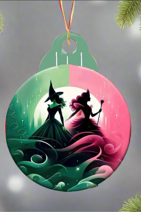 The Kreative Kreationz Wicked Christmas Tree Ornament showcases silhouetted figures of two witches, one with a pointed hat and the other holding a wand, set against swirling colors. Framed by pine branches, this sublimated design is an ideal addition to your holiday decor.