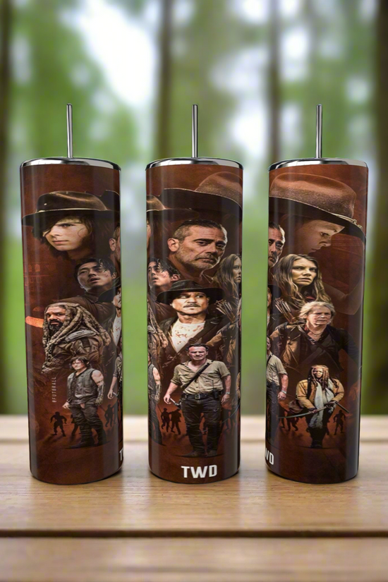 Three Kreative Kreationz Walking Dead 20oz Skinny Tumblers with spill-proof lids and reusable straws rest on a wooden surface. Each features iconic characters from the show against a blurred forest backdrop for added convenience and style.