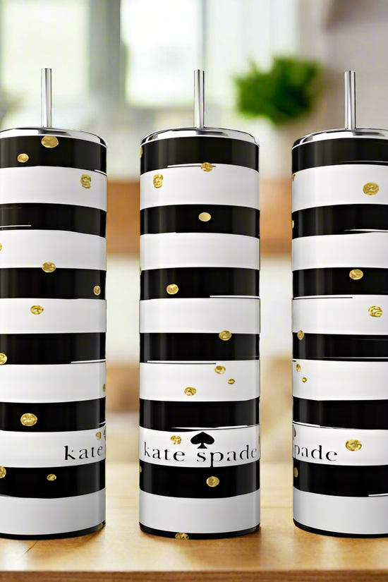 Three Kate Spade Sparkle 20oz Skinny Tumblers by Kreative Kreationz with black and white stripes, gold dots, and metallic straws rest on a wooden surface. These stylish stainless steel tumblers are eco-friendly drinkware.