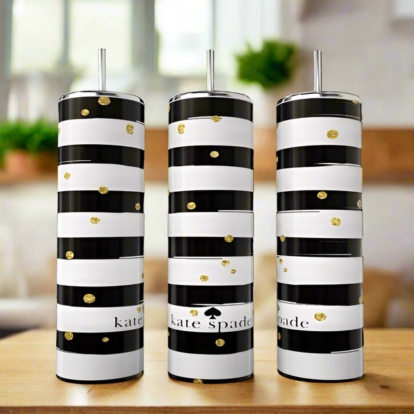 Three Kate Spade Sparkle 20oz Skinny Tumblers by Kreative Kreationz with black and white stripes, gold dots, and metallic straws rest on a wooden surface. These stylish stainless steel tumblers are eco-friendly drinkware.