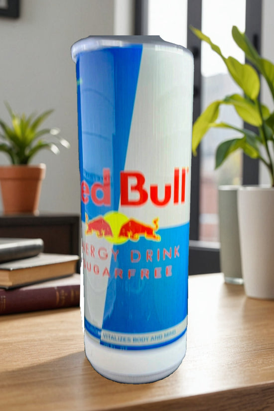 A collection of Red Bull lovers 20oz Tumblers from Kreative Kreationz, each displaying a different Red Bull flavor and distinct vibrant color. Arranged from left to right: Winter Edition (blue), Orange Edition (orange), Beach Edition (peach), Coconut Edition (white), Summer Edition (green), Original (silver), Sugarfree (white and blue stripe), and Tropical (yellow). Perfect for carrying your favorite energy drink without worrying about spills.