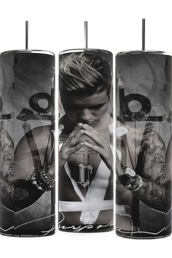 Three cylindrical Justin Bieber Prayer 20oz Tumblers by Kreative Kreationz feature monochrome images of a contemplative Justin Bieber, adorned with tattoos and wearing a sleeveless shirt and several bracelets. His hands are pressed together in a prayer-like gesture, with the word 
