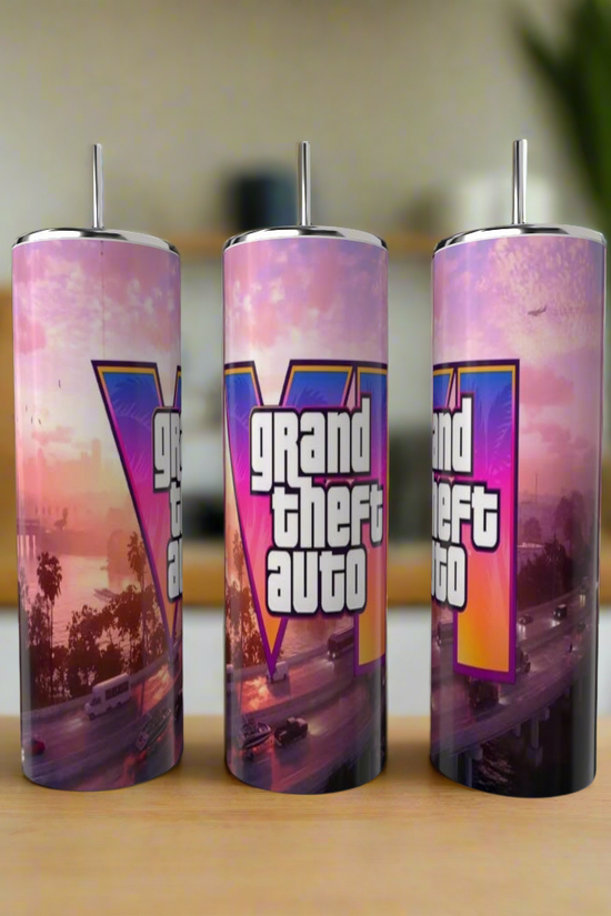Three eco-friendly Kreative Kreationz Grand Theft Auto 20oz Tumblers featuring palm trees, cars, and a sunset design are displayed on a wooden kitchen surface.