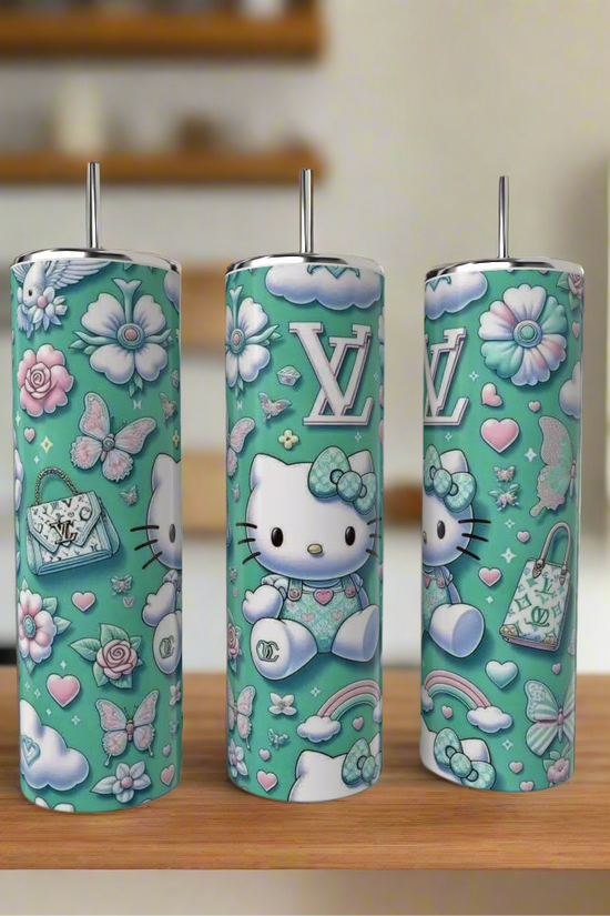 Three teal Hello Kitty LV 20oz Tumblers by Kreative Kreationz, featuring pastel flowers, butterflies, LV logos, hearts, and purses, are displayed on a wooden surface with a blurred kitchen in the background.