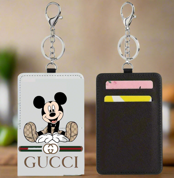Two Kreative Kreationz Mickey Gucci Card Wallets are shown: one slim wallet features Mickey Mouse and a Gucci logo, while the other displays card slots with two cards. Both minimalist wallets include metal key rings at the top.