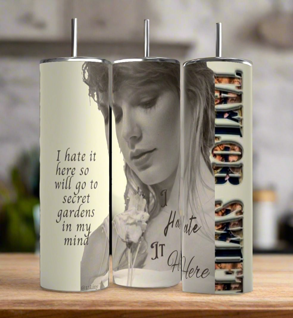 Three Kreative Kreationz Secret Garden Taylor Swift 20oz stainless steel tumblers with metal straws feature black-and-white art, floral designs, the quote "I hate it here so will go to secret gardens in my mind," and spill-proof lids.