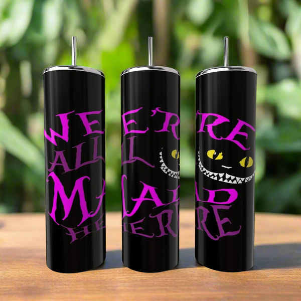 Kreative Kreationz's "We Are All A Little Mad Here" 20oz tumbler features bold pink lettering, a wide grin, and yellow cat eyes inspired by the Cheshire Cat—an Alice in Wonderland eco-friendly drinkware choice.