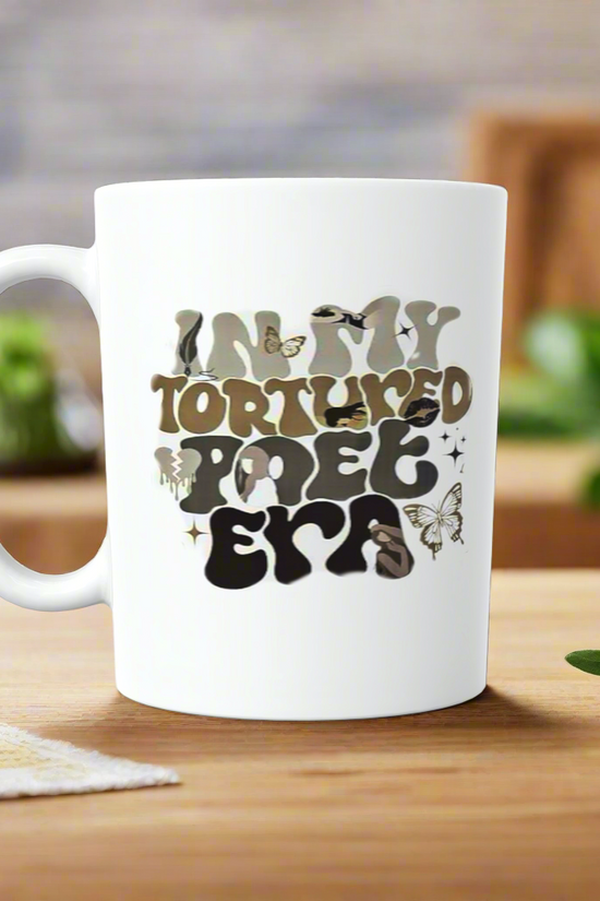 The Kreative Kreationz IN MY TTPD ERA Ceramic Mug features a wavy-font design with butterflies and birds—an ideal gift for any Swiftie or Taylor Swift fan. Perfect as a coffee mug or tea cup from the TTPD collection!.