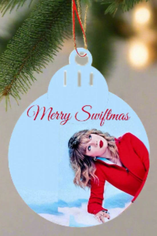 A festive decorator's delight, the Merry Swiftmas Tree Ornament by Kreative Kreationz features a woman in red against a blue background. 