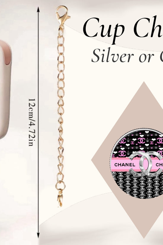 The handcrafted Chanel Charm Dangle by Kreative Kreationz features a circular pendant with a black and white pattern, pink accents, and hangs from a 12cm gold chain. Ideal for enhancing your beige cup, it comes in silver or gold options.