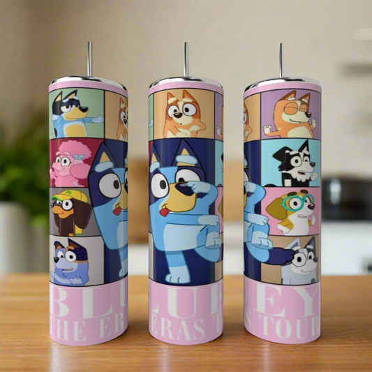 Three Bluey ERAS 20oz Stainless Steel Tumblers by Kreative Kreationz, featuring colorful show characters, are displayed on a wooden surface with a blurred kitchen background.