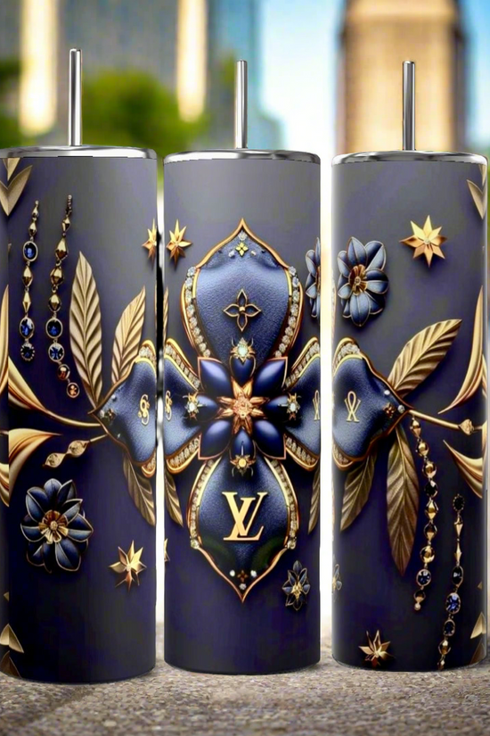 Three dark blue cylindrical tumblers, inspired by the luxury GUCCI Diana design and crafted by Kreative Kreationz, each featuring a textured pattern. These elegant tumblers boast prominent gold and red buckle designs, include a reusable straw, and flaunt a sleek, minimalistic aesthetic against a dark blue background. Each tumbler has an impressive 20 oz capacity.
