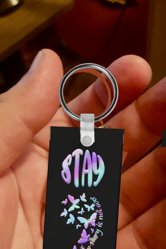 A hand holds the Semicolon Suicide Prevention Awareness Keychain by Kreative Kreationz, featuring colorful pastel letters spelling 