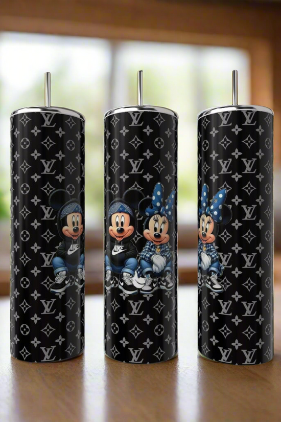 Three Kreative Kreationz Mickey & Minnie Mouse LV Fashion 20oz Skinny Tumblers with metal straws are on display, each featuring the duo in casual outfits amidst Louis Vuitton-inspired monogram patterns.