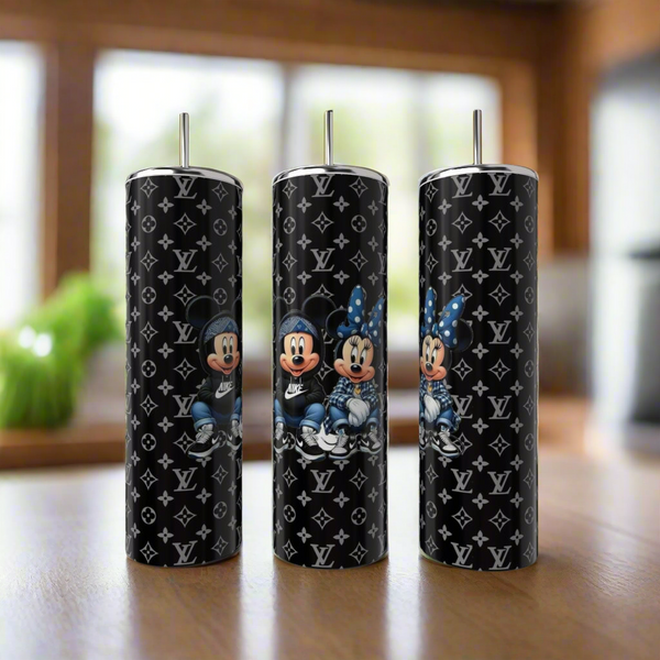 Three Kreative Kreationz Mickey & Minnie Mouse LV Fashion 20oz Skinny Tumblers with metal straws are on display, each featuring the duo in casual outfits amidst Louis Vuitton-inspired monogram patterns.