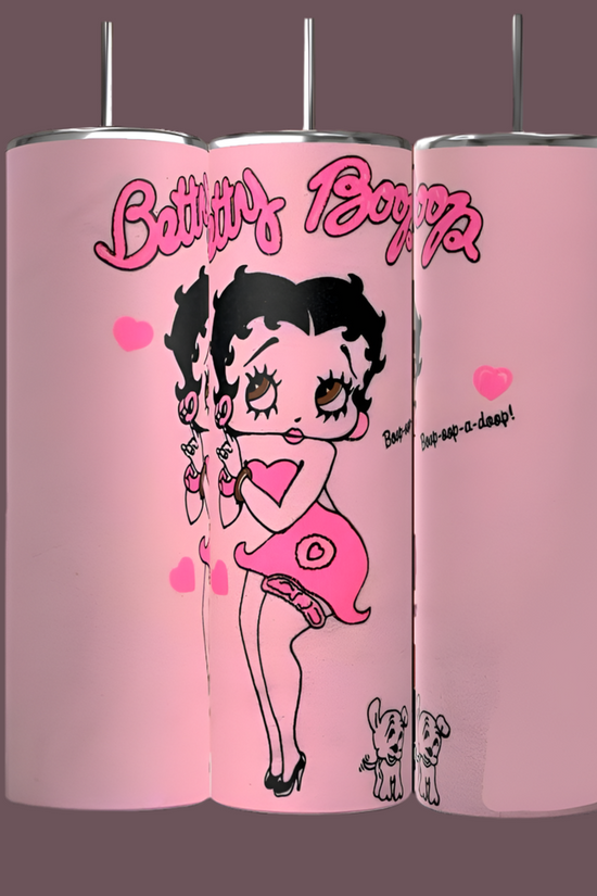 The BB 20oz Skinny Tumblers by Kreative Kreationz feature three designs of Betty Boop in a heart-themed outfit with two small dogs and heart graphics on a dark pink backdrop. These durable, sublimated tumblers are both stylish and long-lasting.