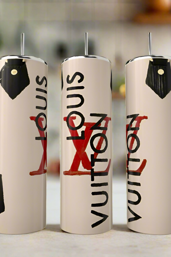Three 20oz stainless steel tumblers by Kreative Kreationz showcase a Louis Vuitton tan purse design with stylish black lettering and red accents, arranged on a kitchen counter with a blurred background.