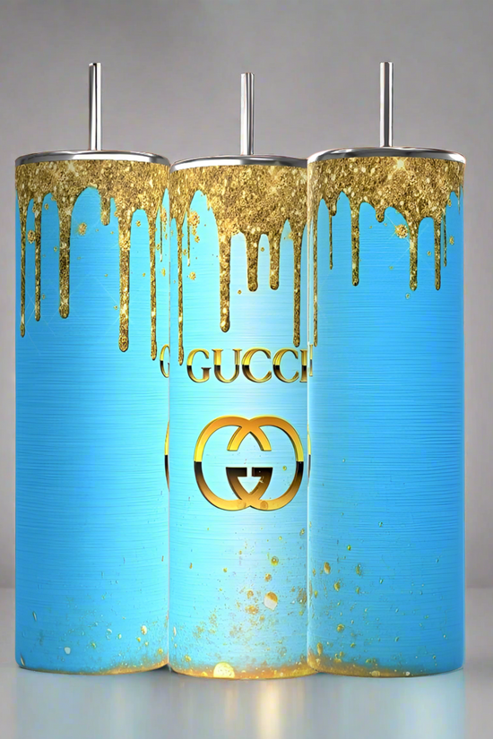 Three Kreative Kreationz Gucci Blue Drip 20oz Tumblers with spill-proof silver lids and straws are displayed, each featuring a blue background with gold paint drips and a striking gold logo inspired by a luxurious GUCCI aesthetic.