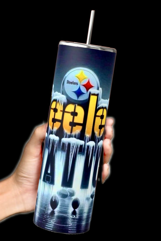A hand holds a tall Steelers Nation - 20oz Skinny Tumbler by Kreative Kreationz, featuring a futuristic design with vivid colors on a black background. It has an insulated body and spill-proof lid, complemented by a metal straw, perfect for team spirit.