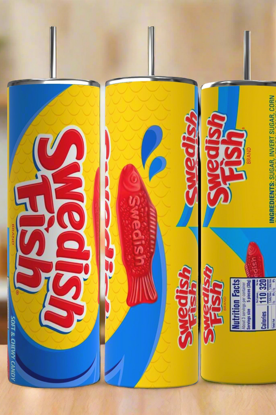 Three cylindrical Swedish Fish 20oz Stainless Steel Skinny Tumblers by Kreative Kreationz are displayed, each featuring a vibrant candy design. Predominantly blue and yellow with red fish graphics and the text 