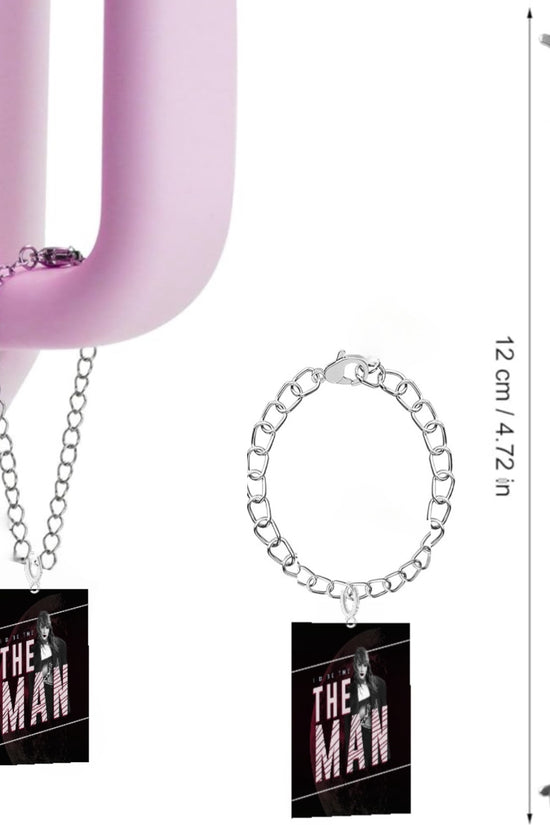 A pink hook suspends a chain with a rectangular tag inscribed 