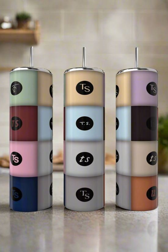 Three pastel, cylindrical spice containers labeled 