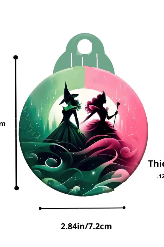 The Kreative Kreationz Wicked Christmas Tree Ornament boasts a sublimated design showcasing two silhouetted figures in green and pink costumes, set against a swirling backdrop. Ideal for holiday decor, these figures face opposite directions. It measures 3.53 inches (9 cm) in height, 2.84 inches (7.2 cm) in width, and 0.12 inches (3 mm) in thickness.