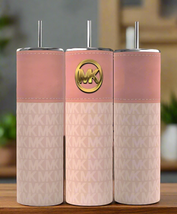 Three Kreative Kreationz stainless steel tumblers, featuring metal lids and straws, sit side-by-side. They have a pink top with a gold Michael Kors logo and a patterned lower section with a repeated MK design, against an elegantly blurred background.
