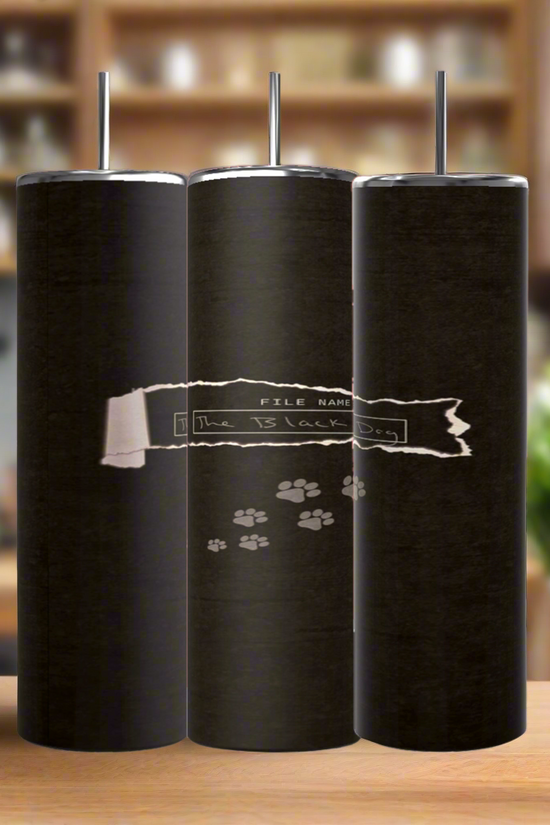 Three tall black TTPD The Black Dog 20oz Tumblers by Kreative Kreationz, each with a metal straw, are shown on a wooden surface. The center tumbler features “The TS Lock Box” and paw prints. Blurred kitchen background.