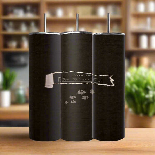 Three tall black TTPD The Black Dog 20oz Tumblers by Kreative Kreationz, each with a metal straw, are shown on a wooden surface. The center tumbler features “The TS Lock Box” and paw prints. Blurred kitchen background.
