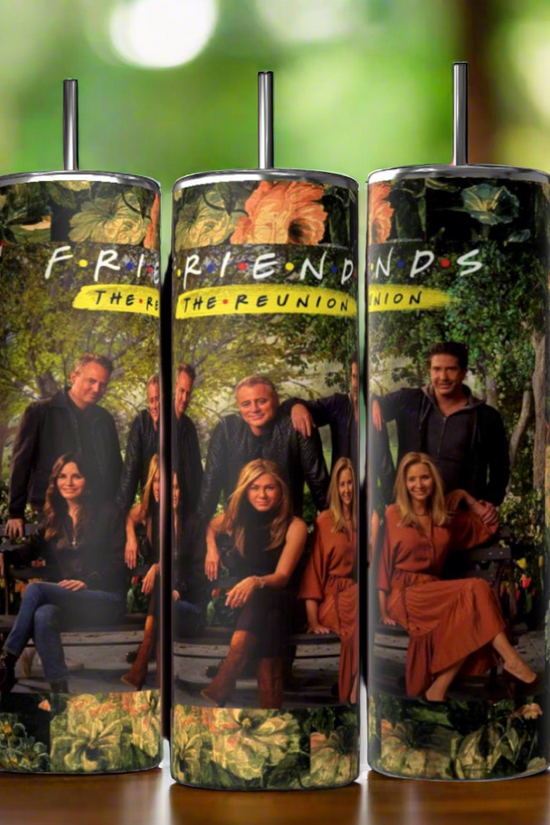 Three cylindrical tumblers are displayed against a black background. Each Kreative Kreationz The Reunion Friends TV Show 20oz Tumbler features an image of a group of people sitting and standing in front of a lush, green background with the text 