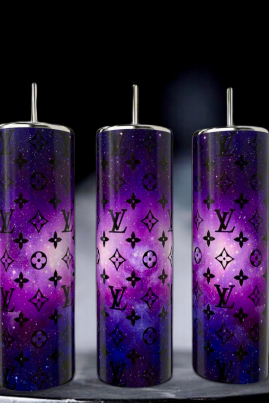 Kreative Kreationz's LV Cosmo 20oz Skinny Tumblers are three tall, double-wall stainless steel tumblers with reusable metallic straws, featuring a purple galaxy design and sleek black logos on a dark background. They're perfect for stylishly enjoying your favorite drinks on the go.