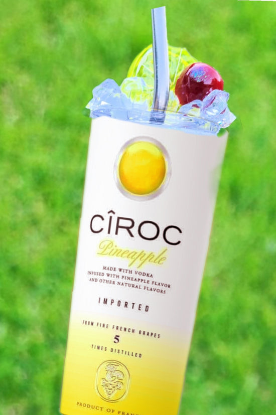 Two cans of Kreative Kreationz Ciroc 20oz Tumbler with 3D Lid Topper are shown on a wooden surface, reminiscent of travel tumblers. The left can is Red Berry flavor, topped with ice and a cherry. The right can is Vodka Snap Frost flavor, topped with ice and a lemon slice. Both cans feature product information and branding.