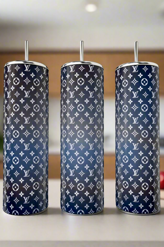 Three LV Ombre 20oz Skinny Tumblers by Kreative Kreationz sit on a kitchen counter, each with a navy and black gradient seamless design featuring white designer-style logos, and come with metal straws.