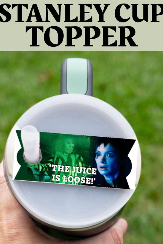 A hand holds a Beetlejuice The Juice Is Loose Stanley Lid Topper by Kreative Kreationz, featuring a blue-lit face with the text 