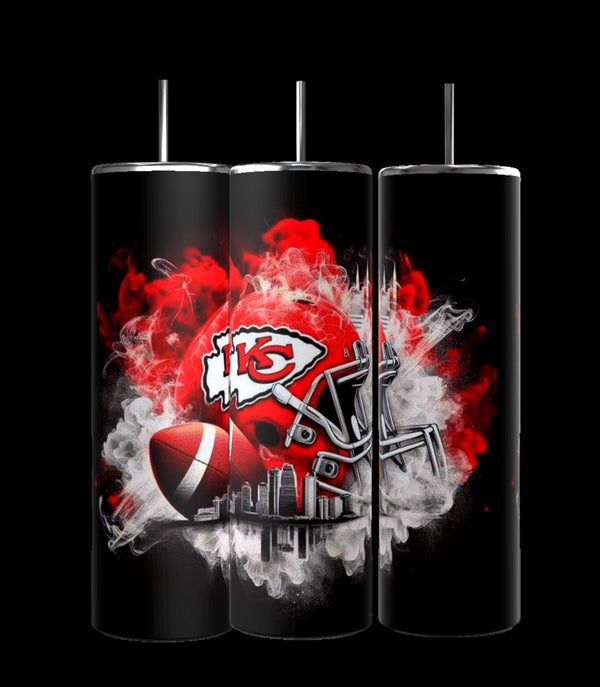 Three black insulated Kreative Kreationz Kansas City Chiefs tumblers feature red and white designs. The central stainless steel tumbler displays a red football helmet and ball with smoke-like effects around a prominent "KC" logo. Each includes a reusable straw for convenience.