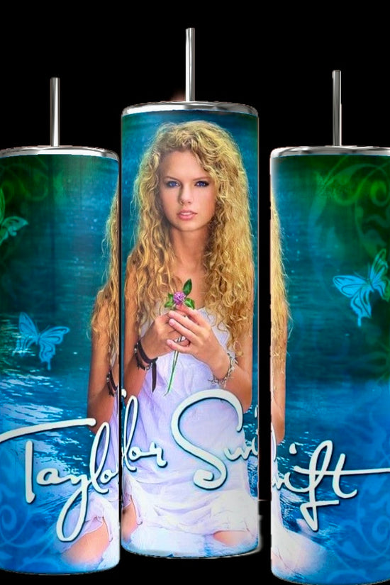 The Debut Taylor Swift 20oz Tumblers by Kreative Kreationz come in a set of three, each with reusable metal straws and spill-proof lids. They feature an image of a woman with curly blonde hair holding a green object, set against a background of green swirls and butterflies. The name 