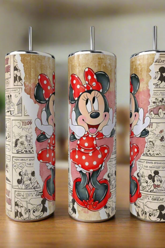 The Minnie Mouse 20oz Skinny Tumblers by Kreative Kreationz feature Minnie in a red polka-dot dress with vintage Mickey comic strip backgrounds, shown resting on a wooden surface in a softly blurred kitchen.