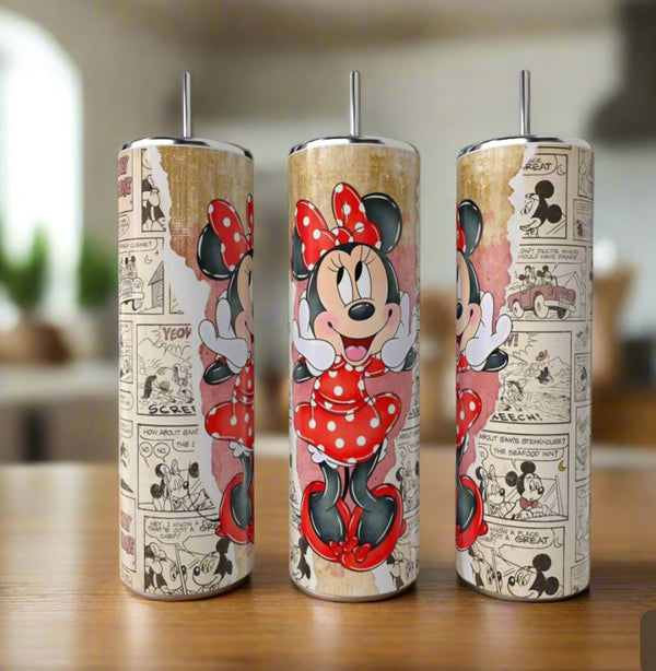 The Minnie Mouse 20oz Skinny Tumblers by Kreative Kreationz feature Minnie in a red polka-dot dress with vintage Mickey comic strip backgrounds, shown resting on a wooden surface in a softly blurred kitchen.