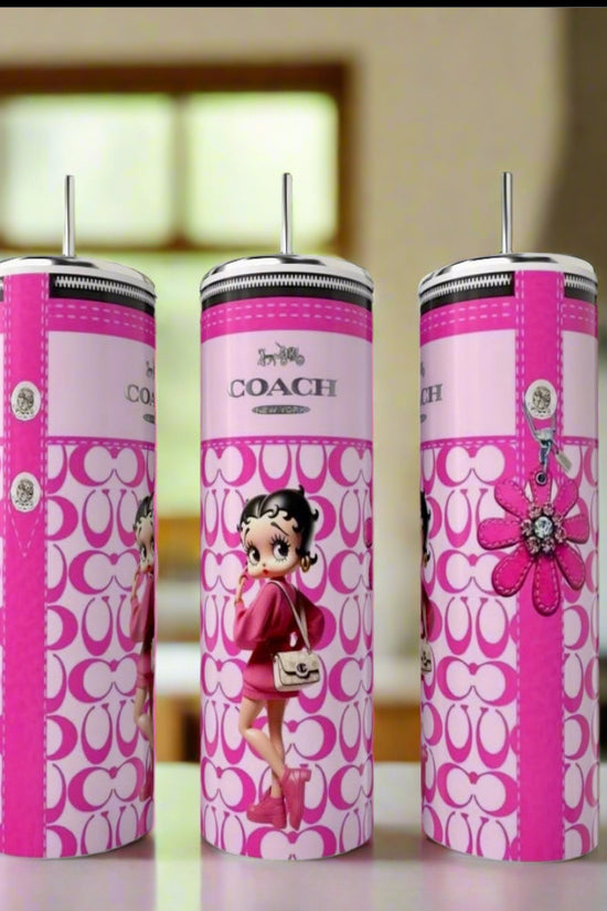 Three tall, pink Kreative Kreationz Betty Boop Designer 20oz Tumblers with straws are displayed on a counter, featuring eco-friendly reusable designs with cartoon graphics and decorative patterns in a blurred kitchen setting.