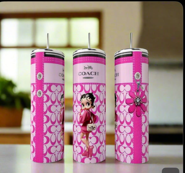 Three tall, pink Kreative Kreationz Betty Boop Designer 20oz Tumblers with straws are displayed on a counter, featuring eco-friendly reusable designs with cartoon graphics and decorative patterns in a blurred kitchen setting.