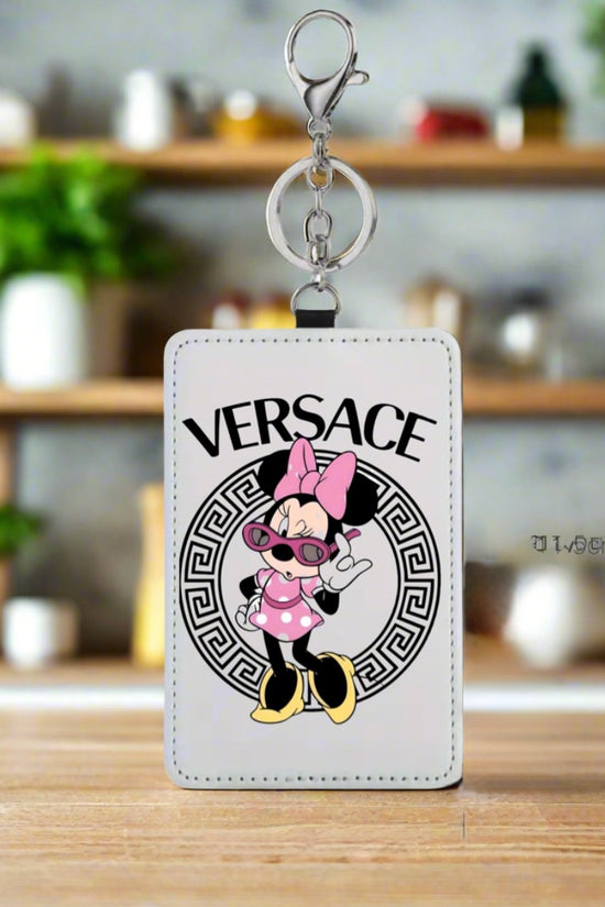 A stylish card wallet by Kreative Kreationz features a white tag with a cartoon mouse in sunglasses, pink bow, and outfit in front of a black Versace-style logo. 