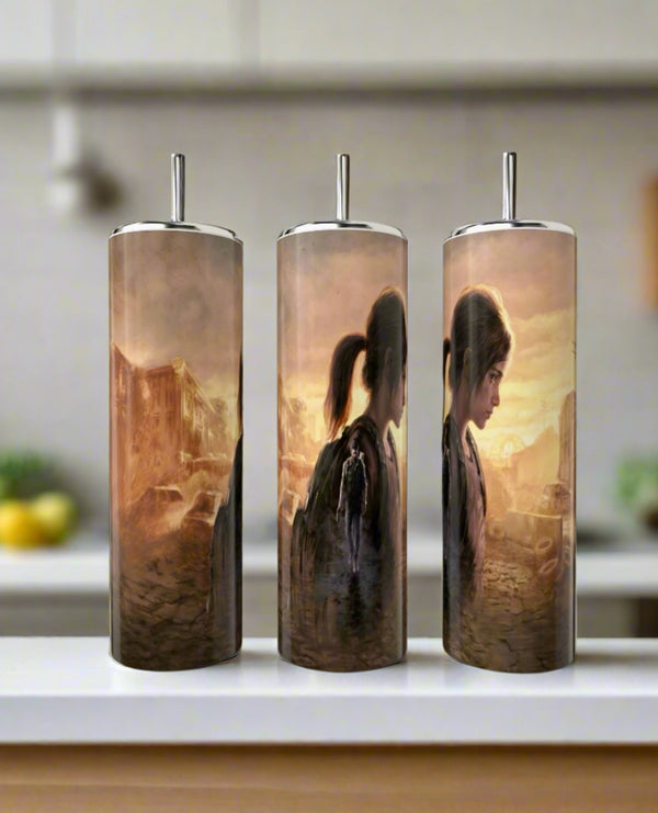 Three Kreative Kreationz 20oz Skinny Tumblers display a sepia-toned, continuous Last Of Us-inspired illustration featuring Ellie with a backpack in a post-apocalyptic city, shown from various angles on a kitchen counter.