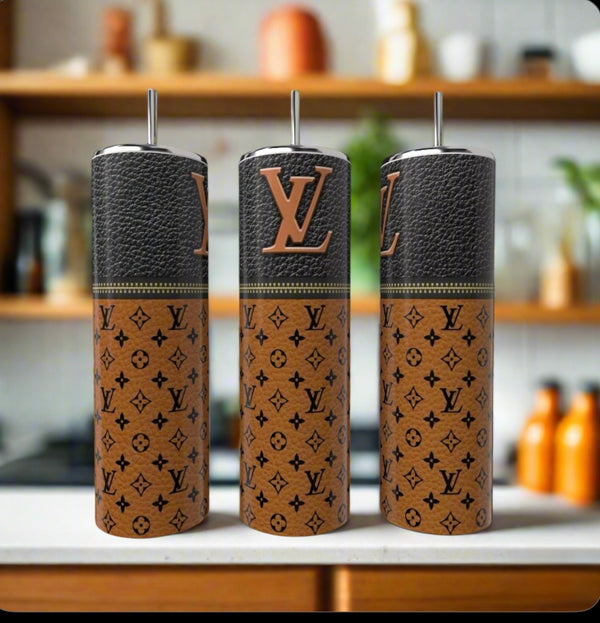 Three LV Brown Zipper 20oz Tumblers by Kreative Kreationz, featuring brown leather-like covers and black Louis Vuitton logos, stand on a kitchen counter, highlighting eco-friendly stainless steel style against a softly blurred background.
