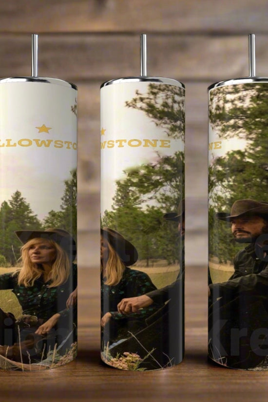 Three Yellowstone 20oz Tumblers by Kreative Kreationz are showcased on a wooden surface. Each stainless steel cylinder displays images of people in hats against trees and sky, with 